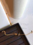 His bracelet is Yves Saint Laurent, golden-1