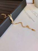 His bracelet is Yves Saint Laurent, golden-9