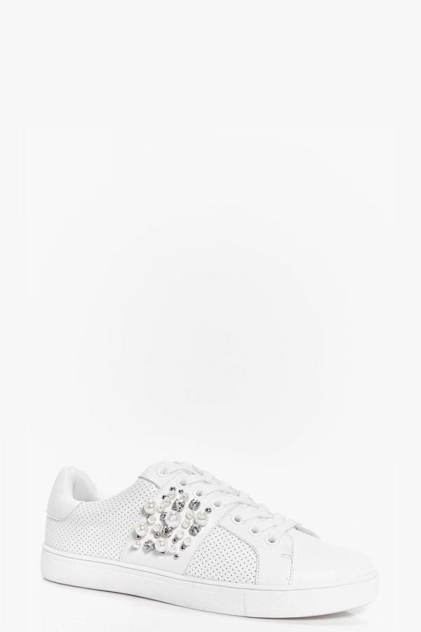 An athletic shoe studded with diamonds and pearls