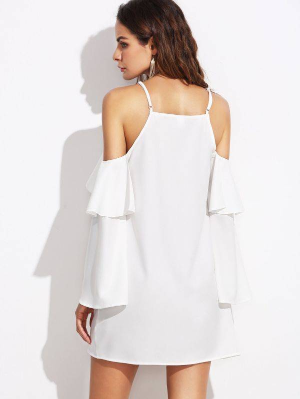 A white dress with open sleeves and a pouch on the sleeves