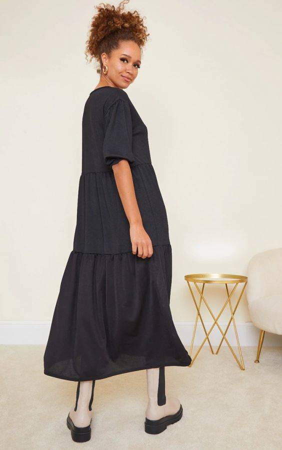 A black midi dress with short puff sleeves