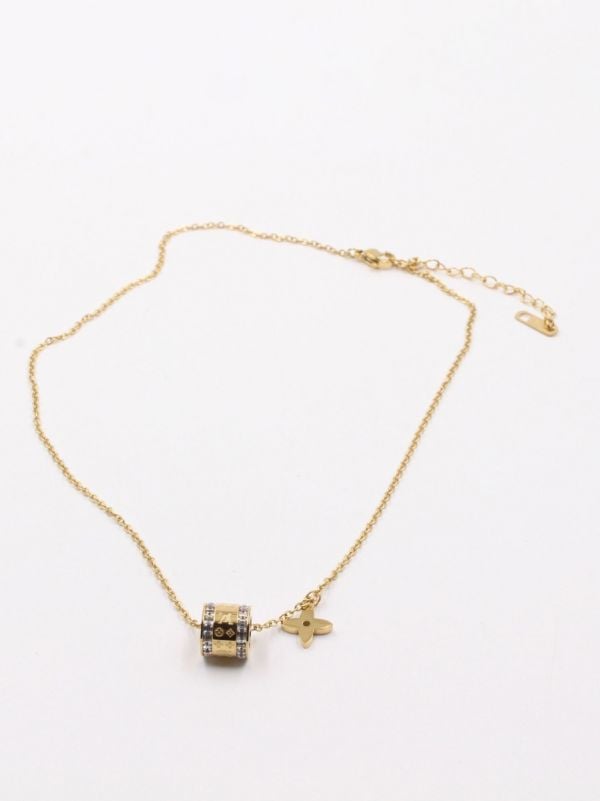 A cylindrical Louis Vuitton necklace